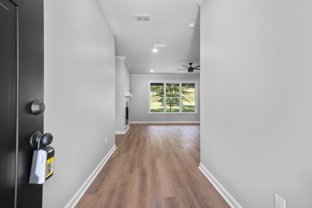 hallway featuring crown molding and wood-type flooring