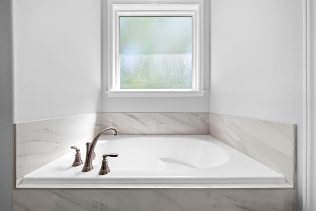 bathroom with tiled tub