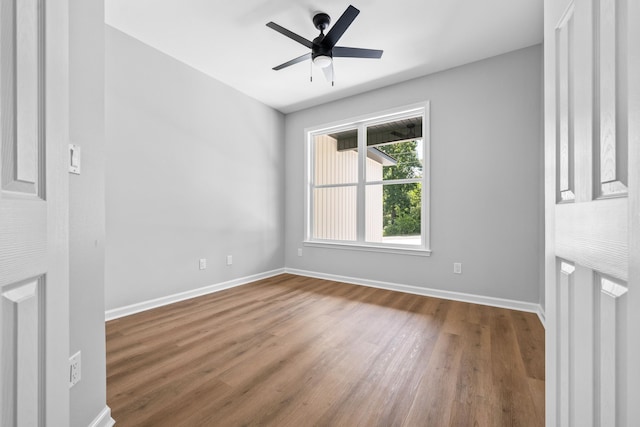 empty room featuring hardwood / wood-style flooring and ceiling fan