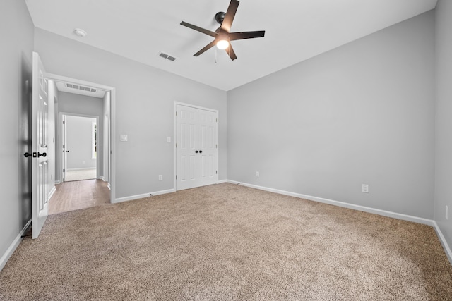 unfurnished bedroom with carpet flooring, ceiling fan, and a closet