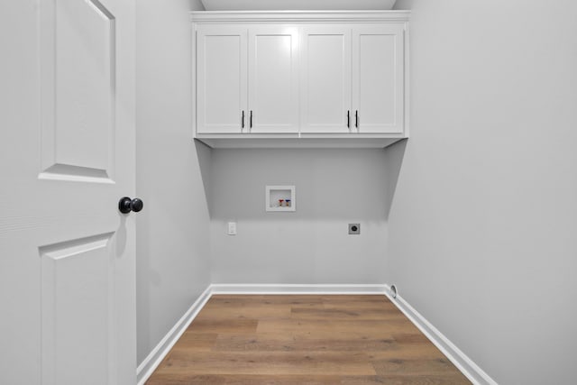 laundry area featuring cabinets, hookup for a washing machine, hookup for an electric dryer, and hardwood / wood-style flooring