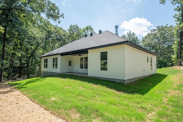 back of property featuring a lawn