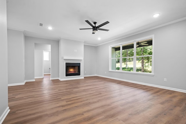 unfurnished living room with crown molding, ceiling fan, and wood-type flooring