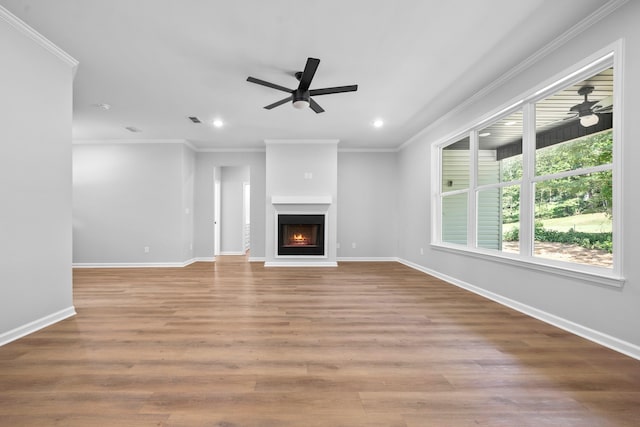 unfurnished living room with crown molding, light hardwood / wood-style floors, and ceiling fan