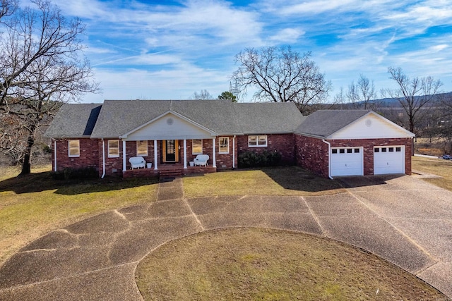 ranch-style home with a garage, covered porch, and a front yard