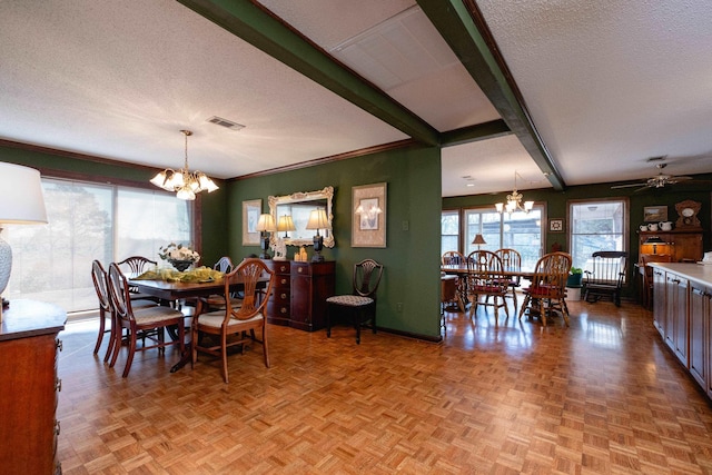 dining space featuring ceiling fan with notable chandelier, beamed ceiling, light parquet flooring, and a textured ceiling