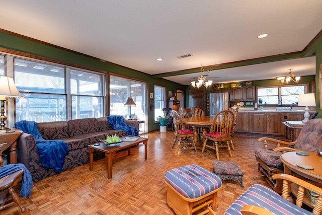 living room featuring a notable chandelier and light parquet flooring