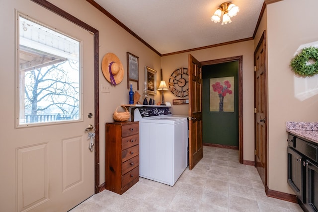 laundry room with crown molding and washer / dryer