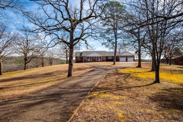 view of front of property with a garage and a front yard