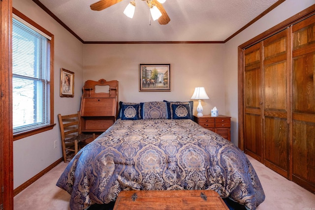 carpeted bedroom featuring crown molding, a textured ceiling, and ceiling fan