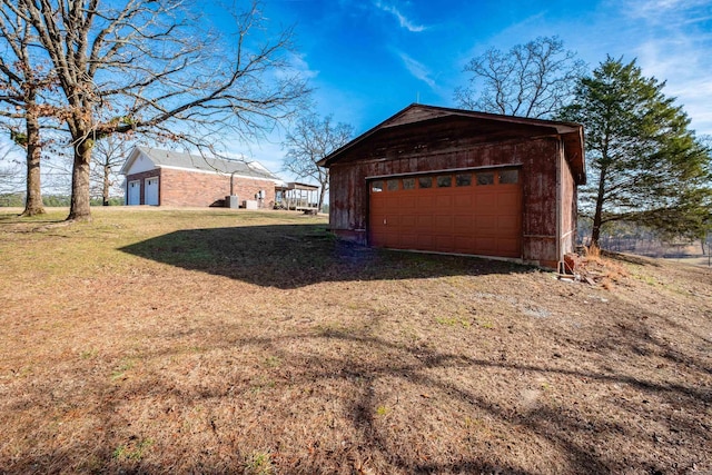 garage featuring a lawn