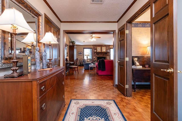 hallway with crown molding, parquet flooring, and a textured ceiling