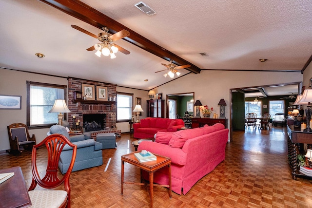 living room featuring vaulted ceiling with beams, parquet flooring, a textured ceiling, and a brick fireplace