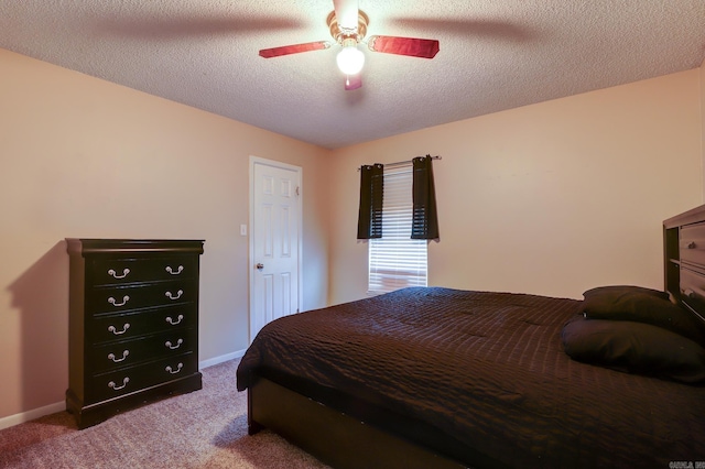 bedroom featuring ceiling fan, carpet, and a textured ceiling