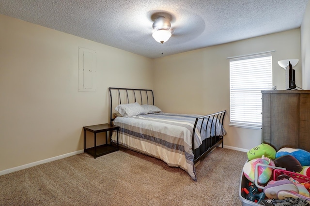 bedroom featuring carpet floors, electric panel, and a textured ceiling