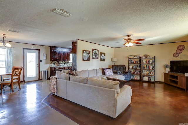 living room featuring ceiling fan and a textured ceiling