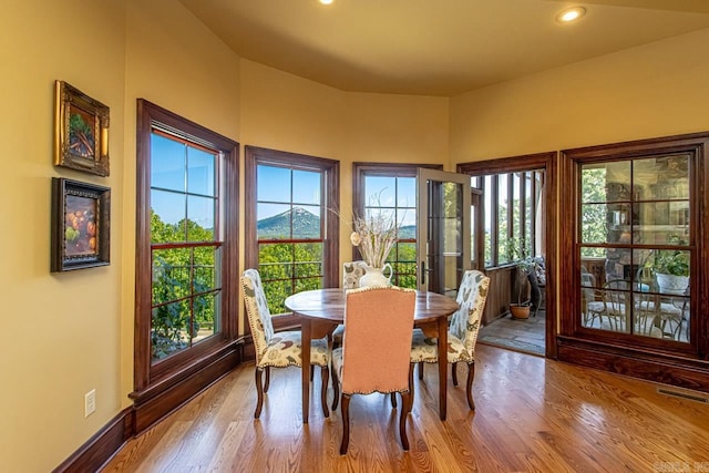 dining area with a mountain view and light hardwood / wood-style floors