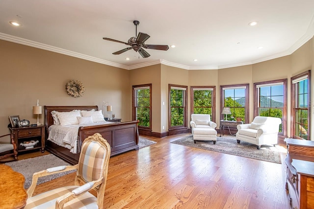 bedroom with multiple windows, ornamental molding, light hardwood / wood-style floors, and ceiling fan