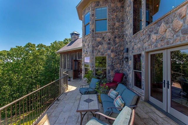 view of patio / terrace with french doors and a balcony