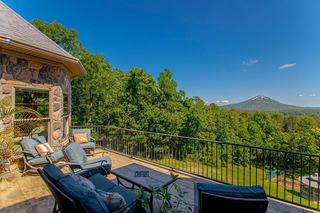 view of patio / terrace with a mountain view and a balcony