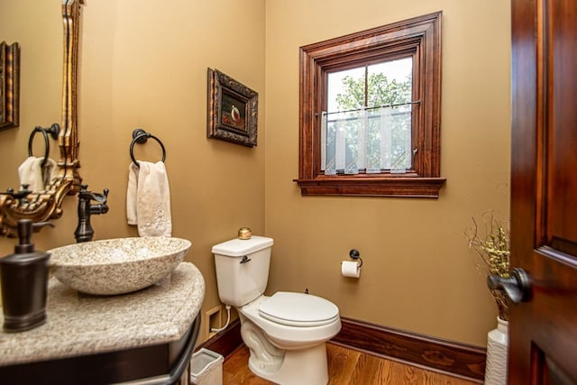 bathroom with vanity, hardwood / wood-style floors, and toilet