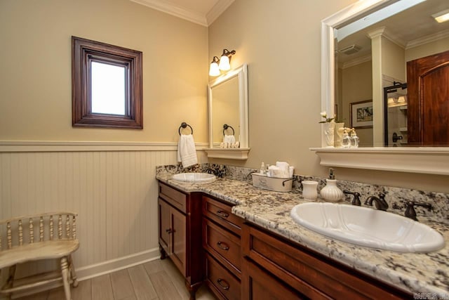 bathroom featuring vanity, hardwood / wood-style floors, and crown molding