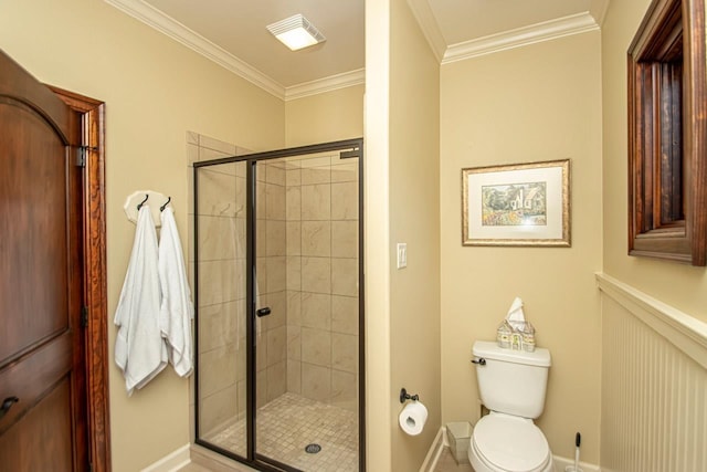 bathroom featuring crown molding, a shower with shower door, and toilet