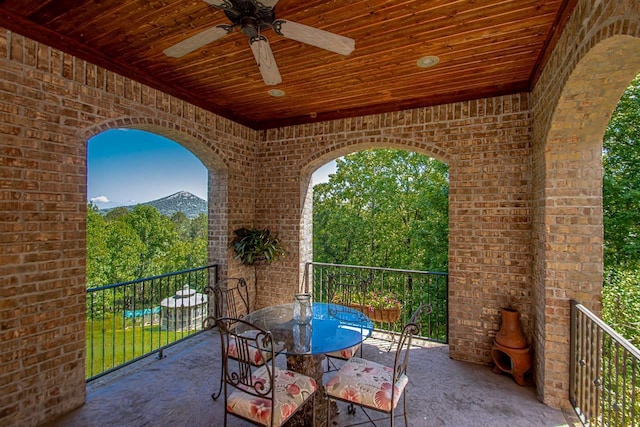 view of patio / terrace featuring ceiling fan and a mountain view