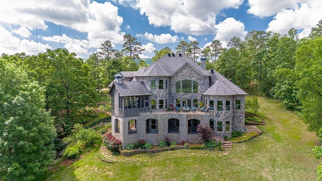 rear view of property with a yard