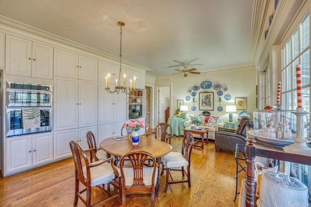 dining room featuring ornamental molding, ceiling fan with notable chandelier, and light wood-type flooring