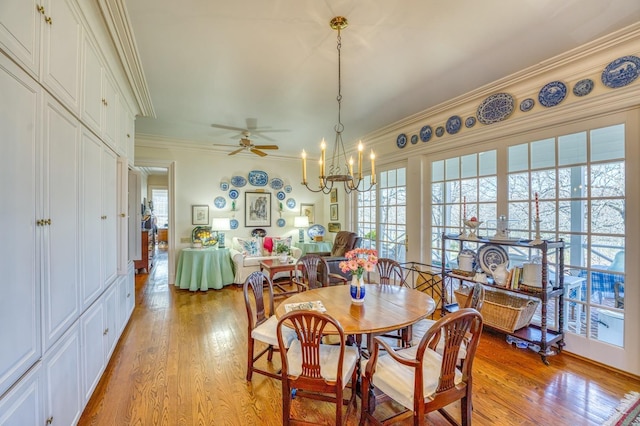 dining room featuring ornamental molding, light hardwood / wood-style floors, and a wealth of natural light