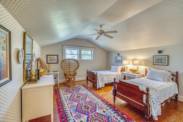 bedroom with hardwood / wood-style flooring, ceiling fan, and vaulted ceiling