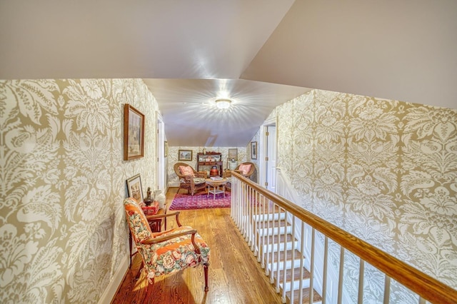 hall with hardwood / wood-style flooring and lofted ceiling