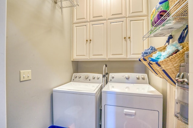 laundry area featuring cabinets and separate washer and dryer