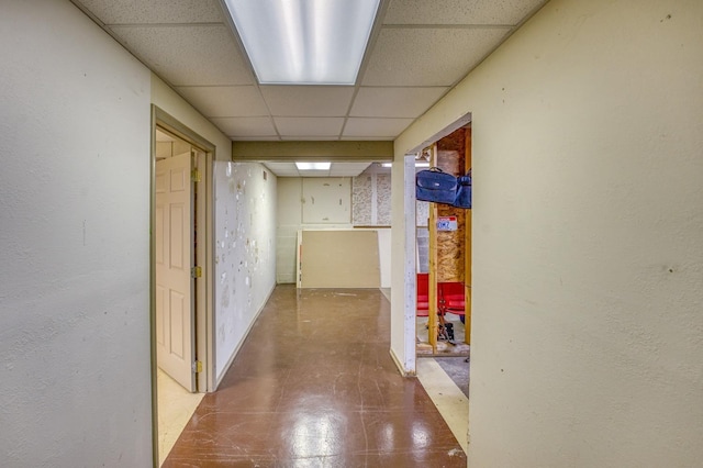 hallway with a paneled ceiling