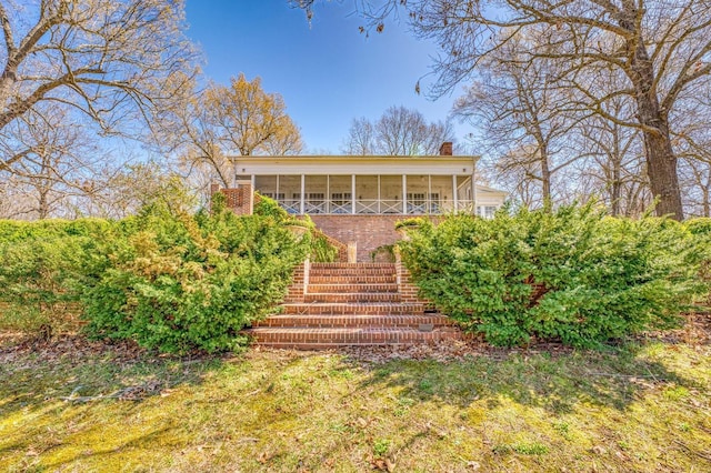 rear view of property with a sunroom