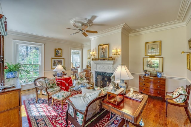 living room with crown molding, hardwood / wood-style flooring, and a high end fireplace