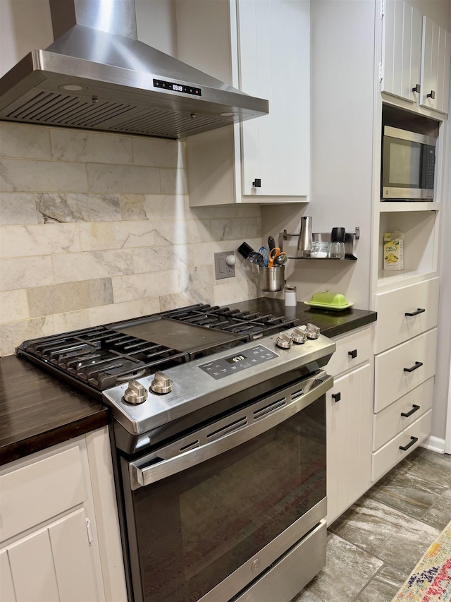 kitchen with white cabinetry, decorative backsplash, range hood, and stainless steel appliances