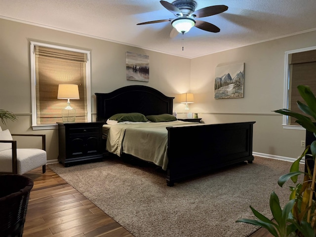 bedroom with ceiling fan, ornamental molding, hardwood / wood-style floors, and a textured ceiling