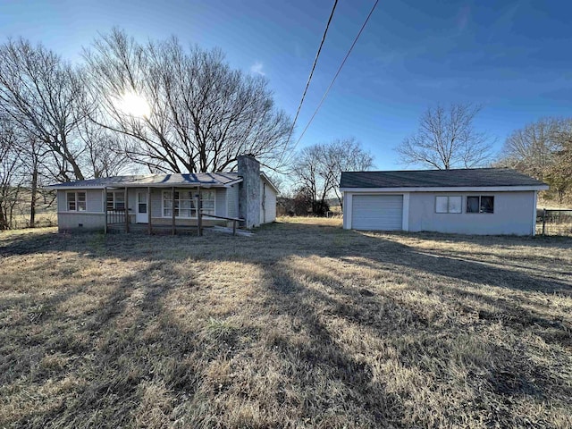 view of front of property with a porch, a garage, and a front yard