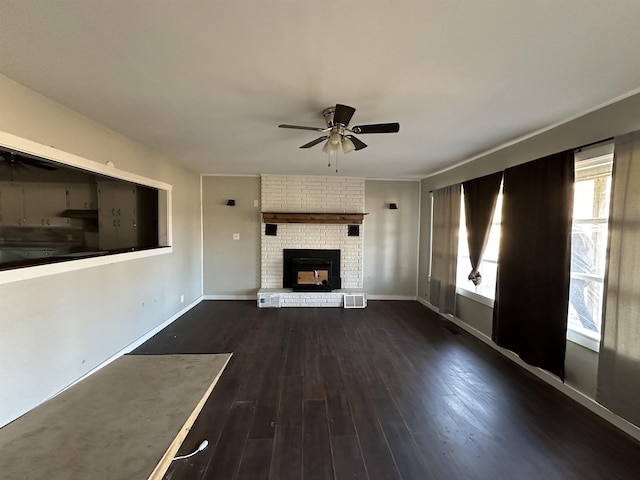 unfurnished living room with dark hardwood / wood-style flooring, ceiling fan, and a fireplace