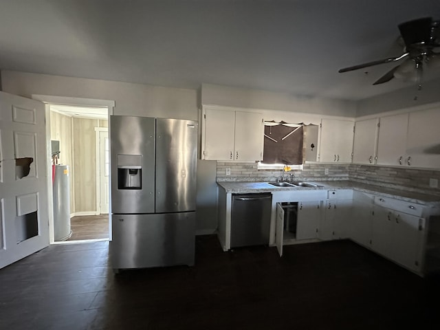 kitchen with backsplash, stainless steel appliances, sink, and white cabinets