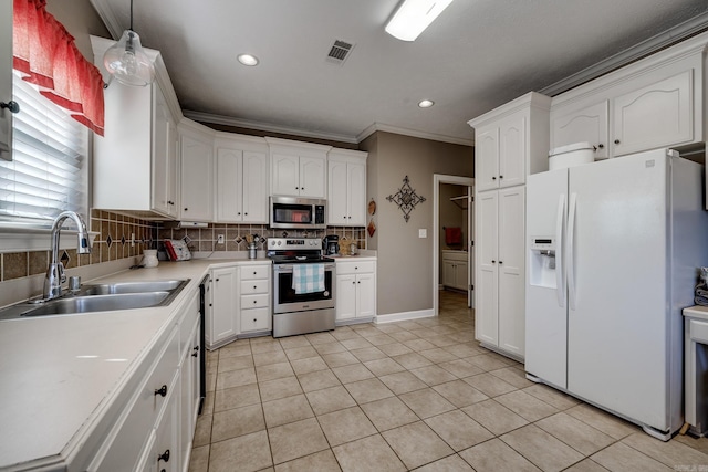 kitchen with sink, hanging light fixtures, stainless steel appliances, white cabinets, and decorative backsplash