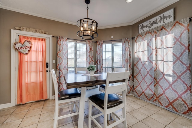 tiled dining space with crown molding and an inviting chandelier