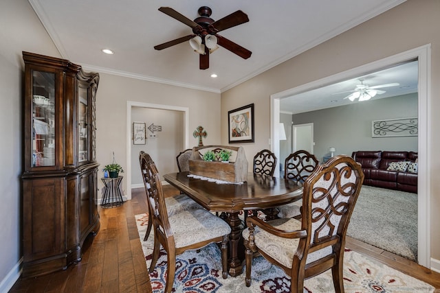 dining area with hardwood / wood-style floors, ornamental molding, and ceiling fan