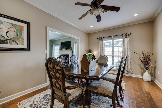 dining space with crown molding, hardwood / wood-style floors, and ceiling fan