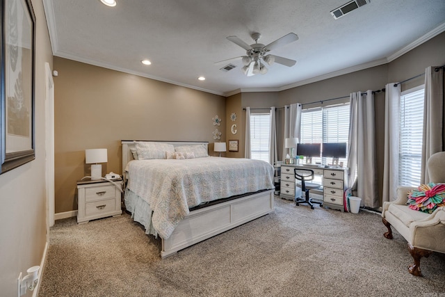 bedroom with ceiling fan, crown molding, light colored carpet, and a textured ceiling