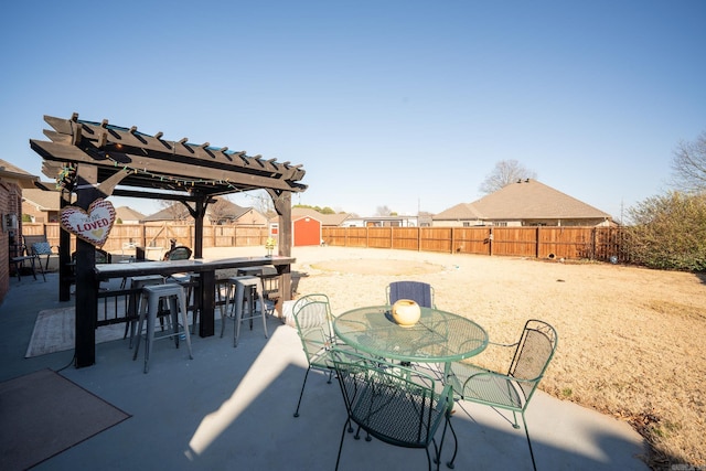 view of patio featuring a bar and a pergola