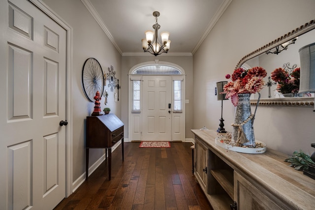 entrance foyer with a notable chandelier, crown molding, and dark hardwood / wood-style floors