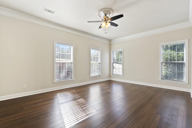 unfurnished room featuring plenty of natural light, ornamental molding, and dark hardwood / wood-style floors